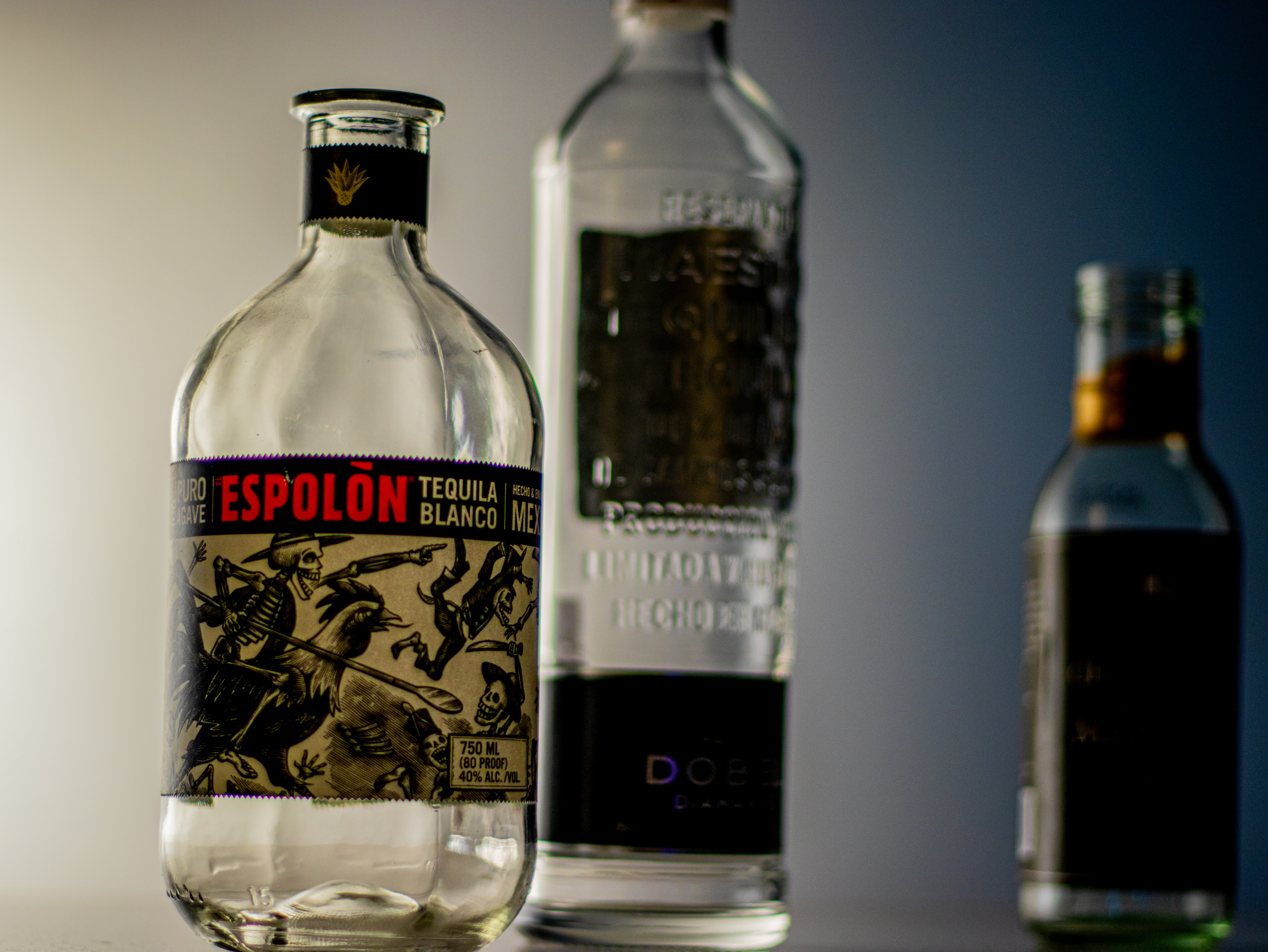 Moody side-lit trio of bottles